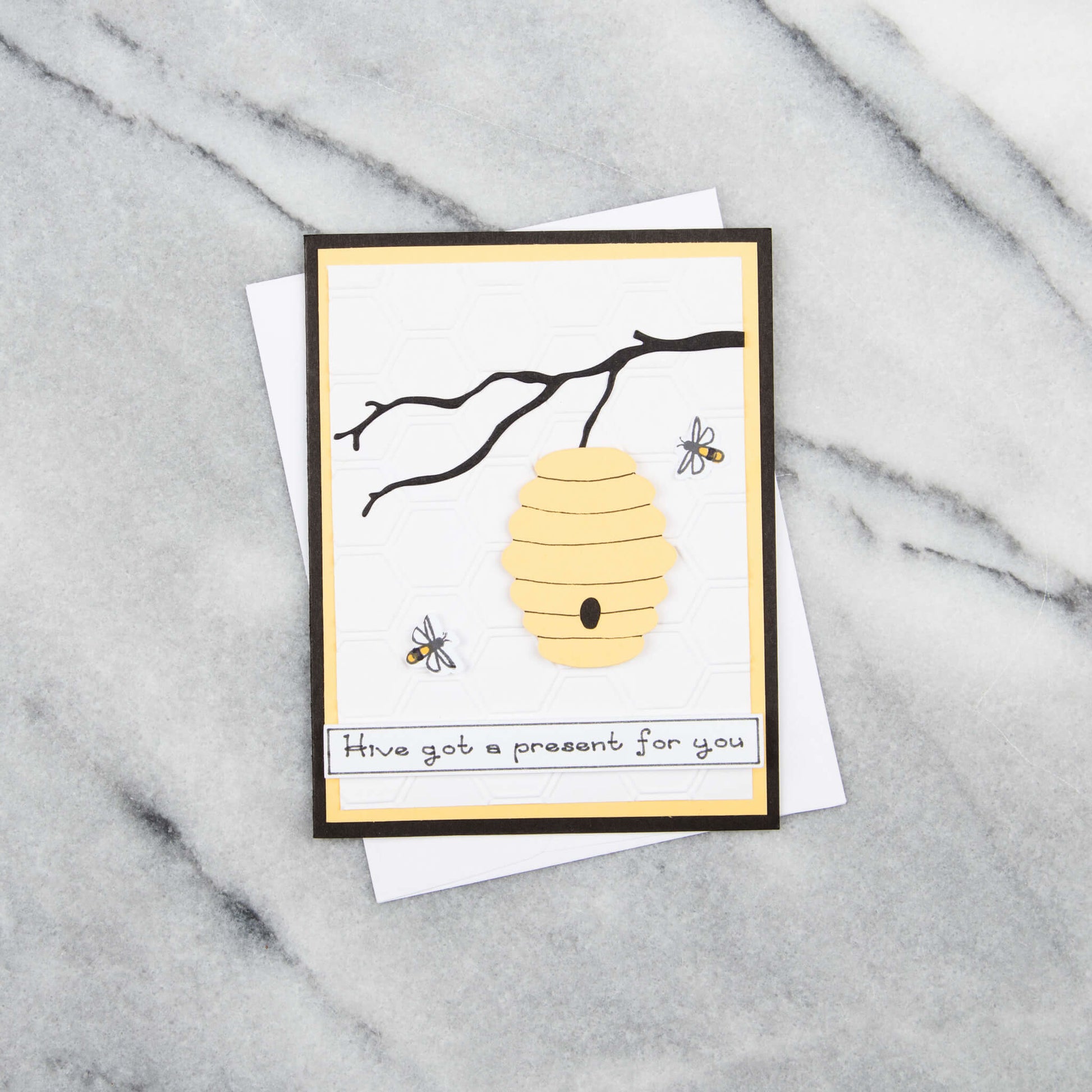 Greeting card with beehive and bees on the cover that says, hive got a present for your
