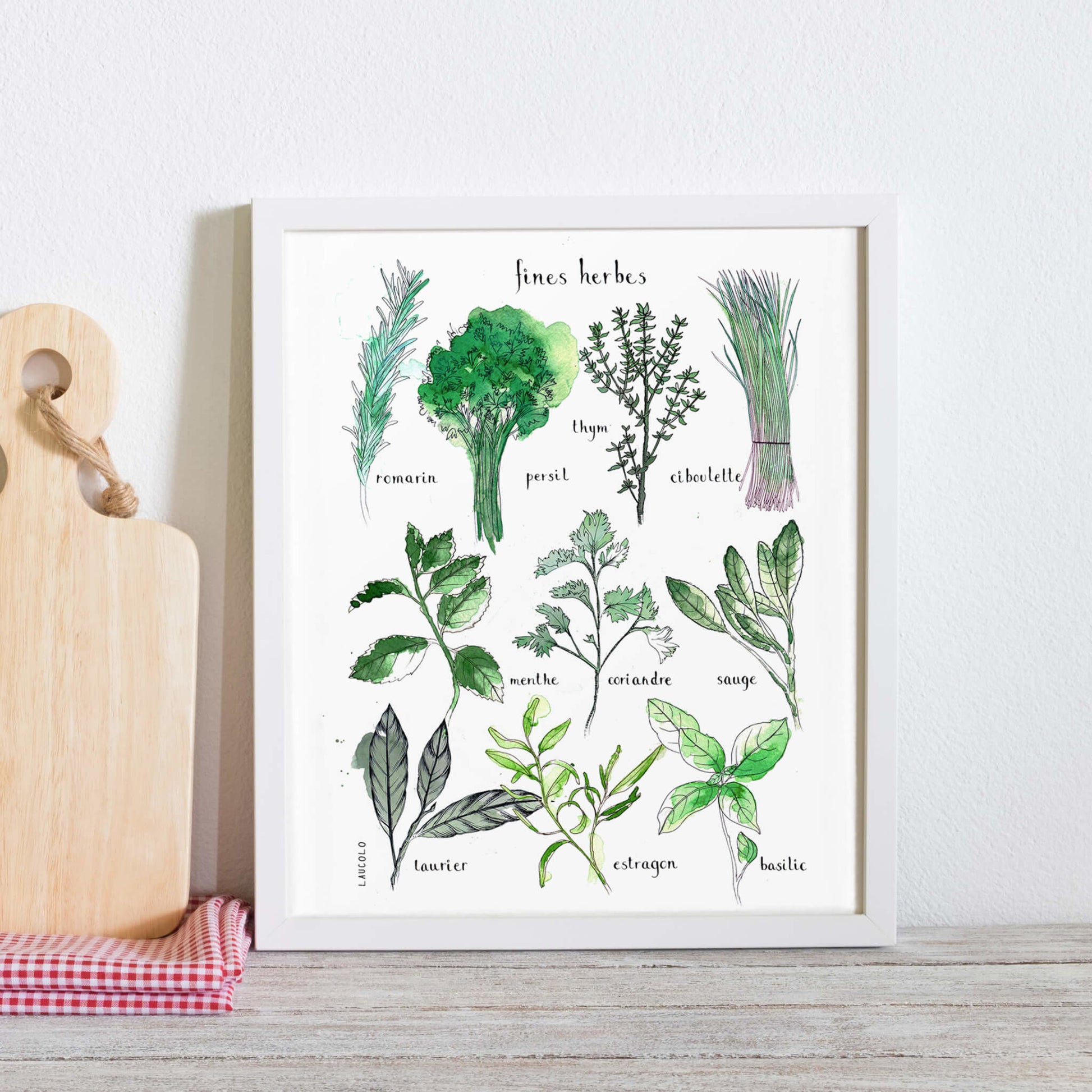 Fine herbs illustration poster leaning against wall in white frame next charcuterie board