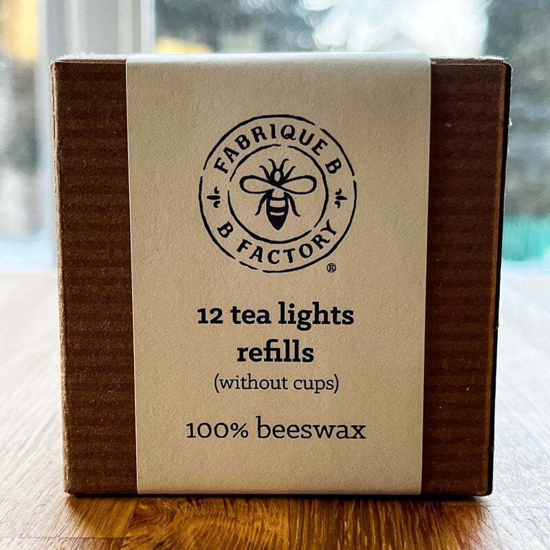 Carboard gift box that says 12 beeswax tea light candle refills without cups, 100% beeswax, by B Factory 