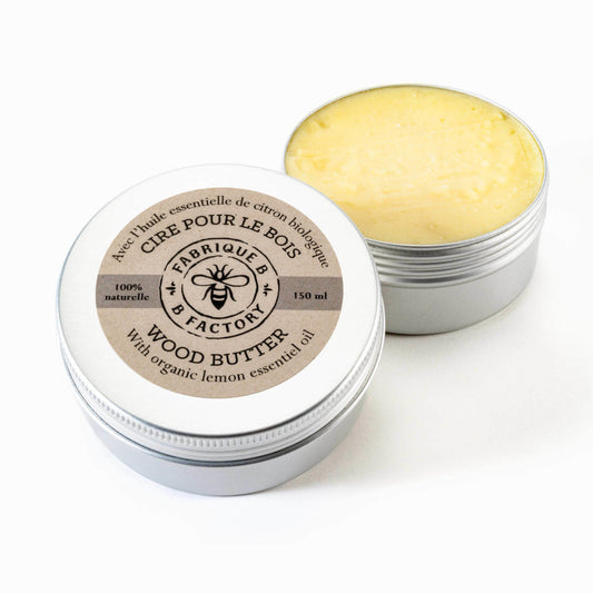 Natural beeswax wood butter in open silver tin with B Factory logo on lid
