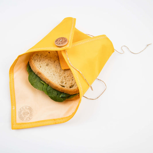Sandwich inside yellow reusable sandwhich wrap 