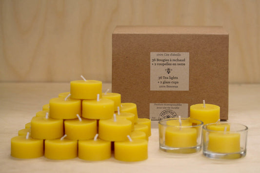 Pyramid of beeswax tea light candles in front of gift box that says 36 tea lights plus 2 glass cups