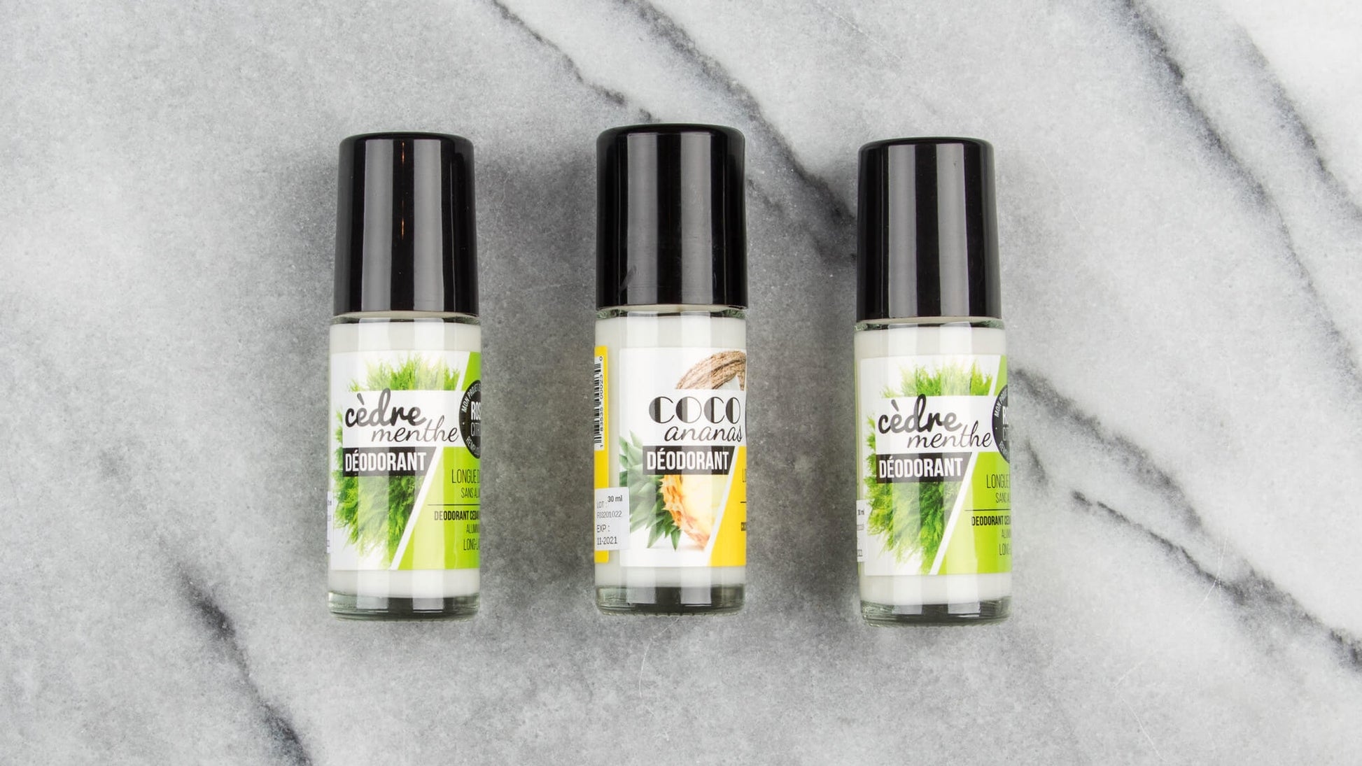 3 30 ml natural roll-on deodorants in glass bottles: 2 cedar-mint, one coconut-pineapple